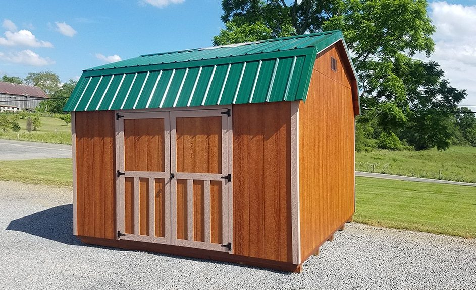 Highwall-barn-wood-siding-mahogany-stain-buscksin-trim-forest-green-metal-roof-943x576