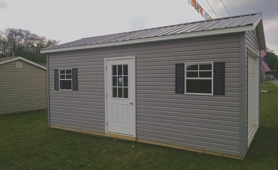weaver-barns-portable-garage-shed-vinyl-siding-metal-roof-943x576