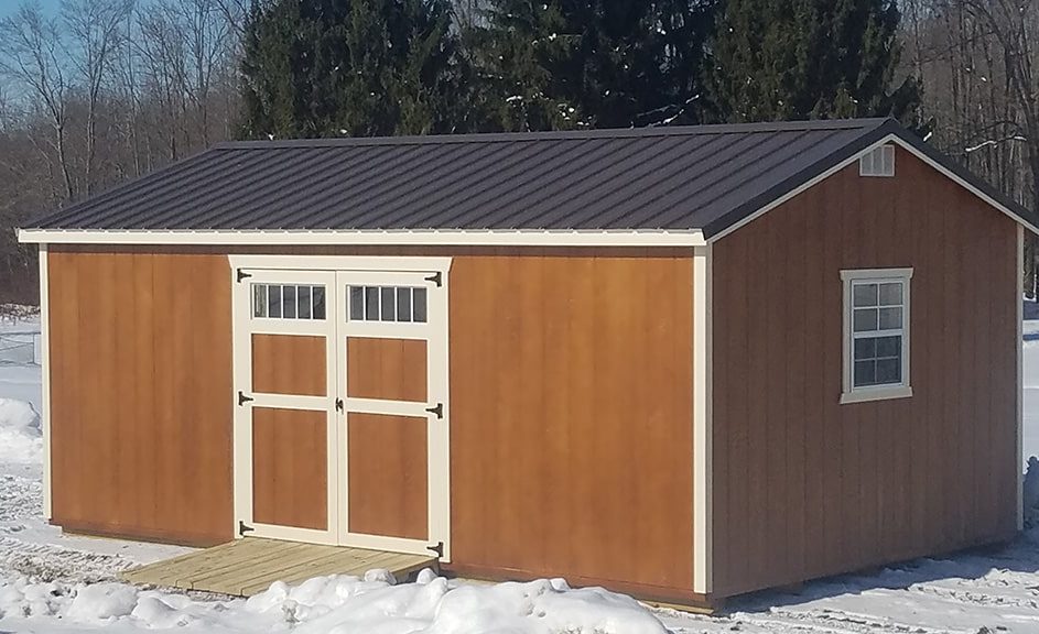 wood-siding-gable-storage-barn-with-butternut-stain-navaho-white-trim-burnished-slate-roof-943x576